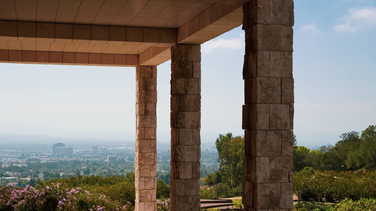Stone columns framing a view over a hazy city