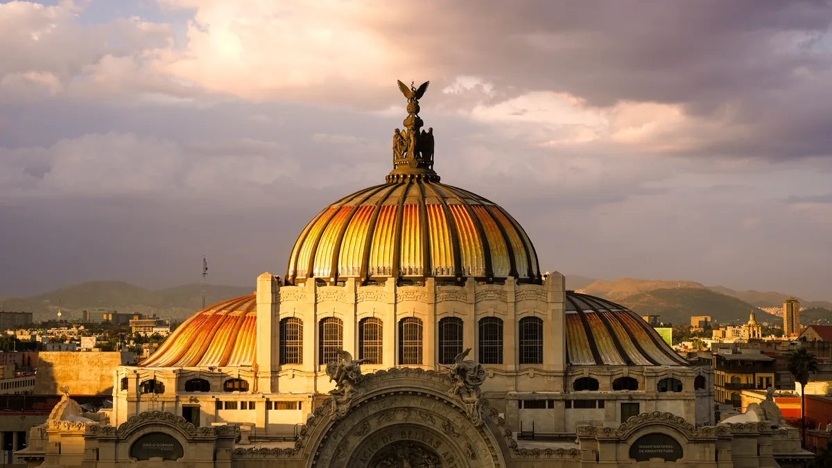 A golden dome under dramatic evening clouds
